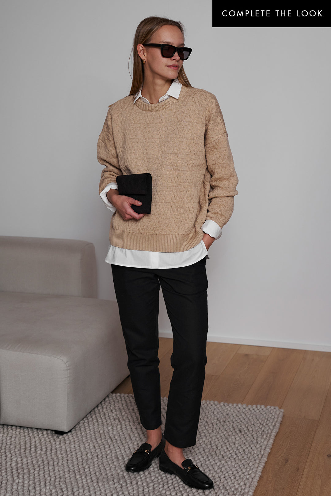 Thick, oversized knitted triangle pullover crafted from organic cotton